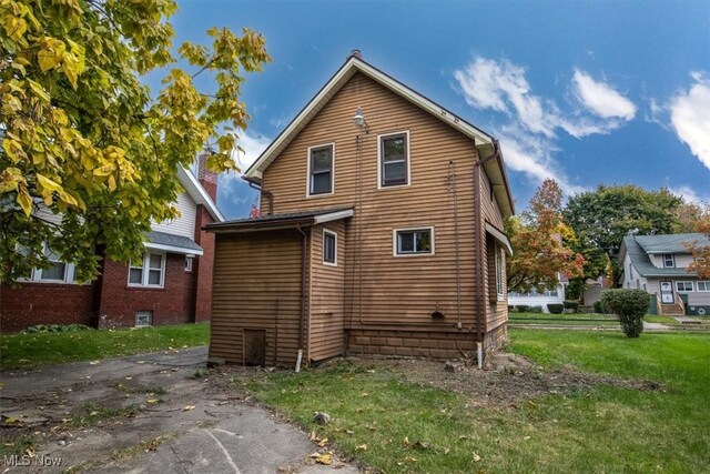 back of house with a yard