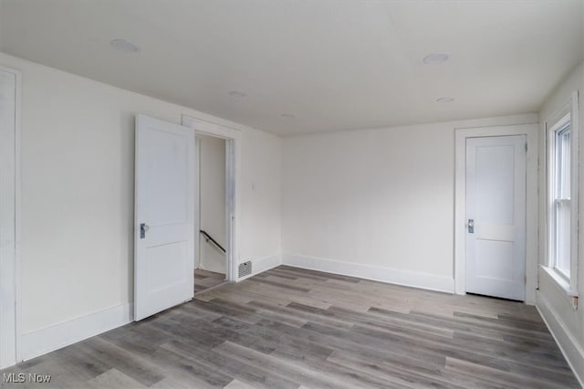 empty room featuring a wealth of natural light and light hardwood / wood-style floors