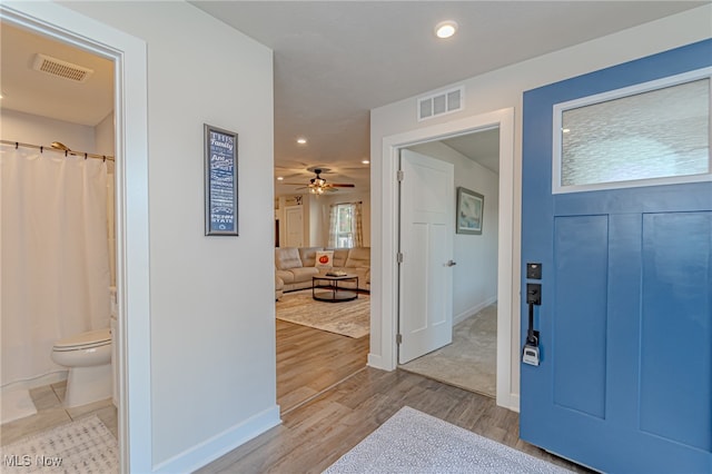 foyer entrance with light wood-type flooring and ceiling fan