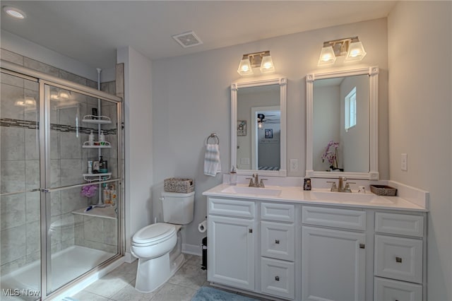 bathroom with toilet, an enclosed shower, vanity, and tile patterned floors