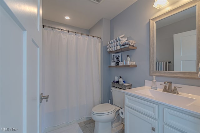 bathroom featuring walk in shower, vanity, toilet, and tile patterned floors