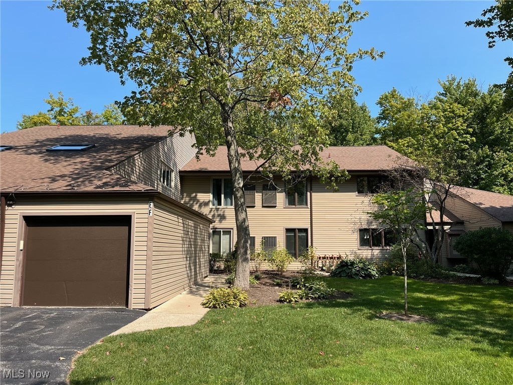 view of front of property with a front lawn and a garage