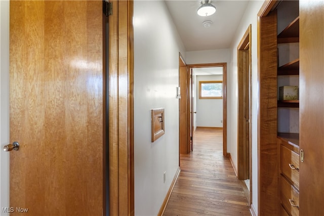 corridor with wood-type flooring