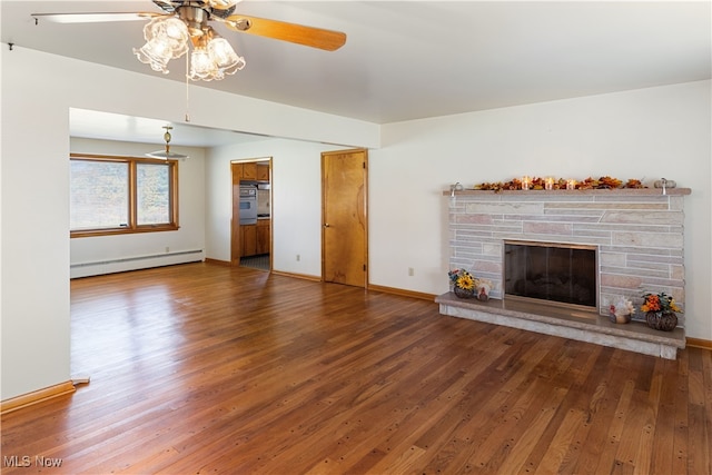 unfurnished living room with hardwood / wood-style floors, baseboard heating, a fireplace, and ceiling fan