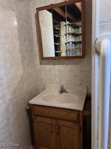 bathroom featuring tile walls and vanity