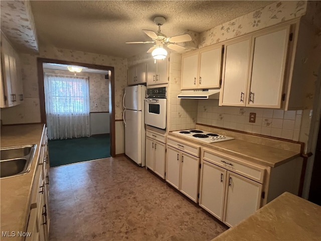 kitchen with white cabinetry, ceiling fan, sink, and white appliances