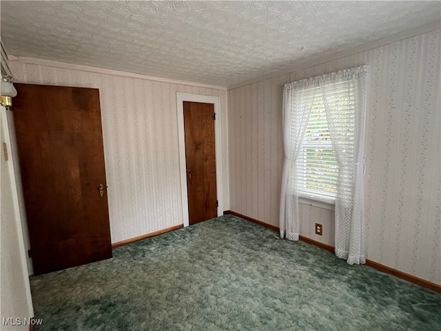 unfurnished bedroom with a textured ceiling and carpet floors