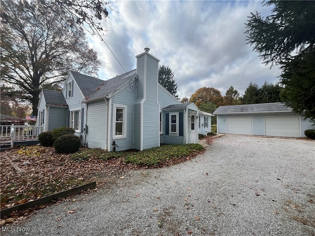 view of home's exterior featuring an outdoor structure and a garage