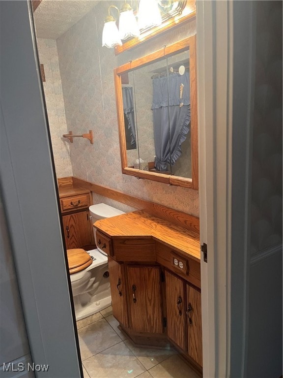 bathroom featuring vanity, toilet, and tile patterned floors