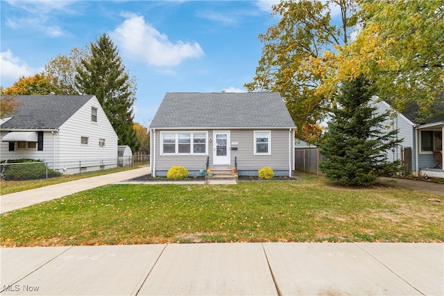 bungalow-style home with a front yard