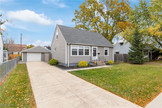 bungalow with a front yard, an outdoor structure, and a garage