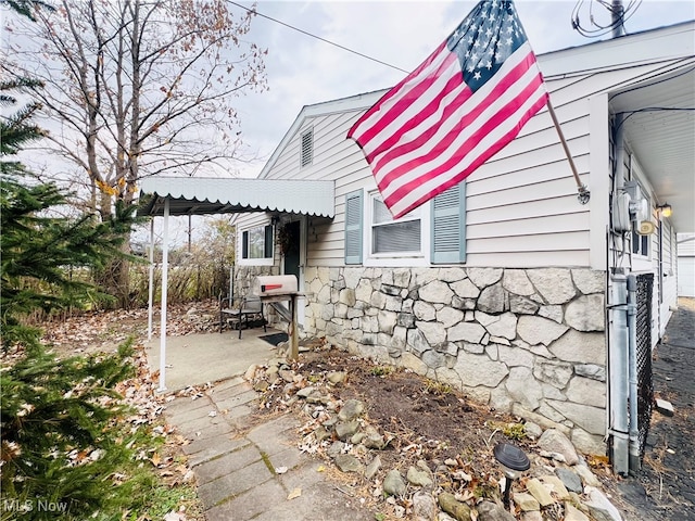 view of property exterior featuring a patio area