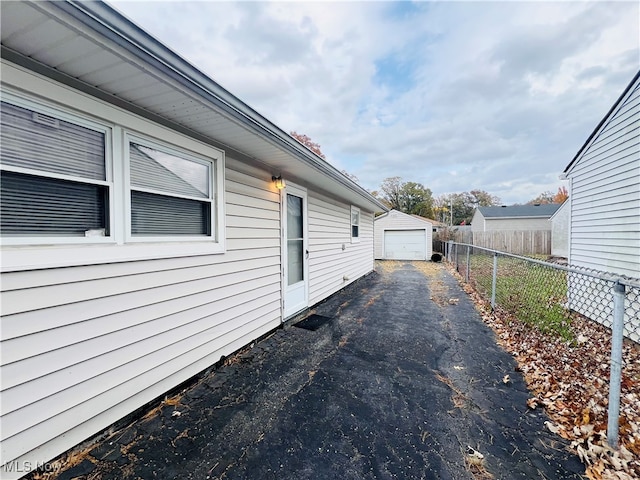 view of property exterior featuring an outbuilding and a garage