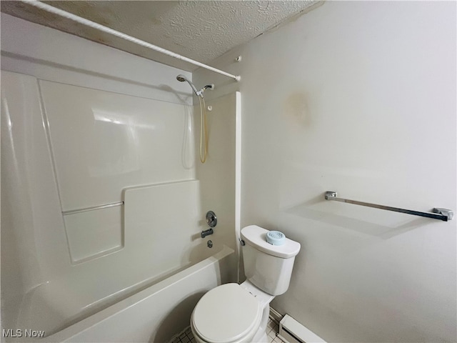 bathroom with shower / washtub combination, a textured ceiling, and toilet