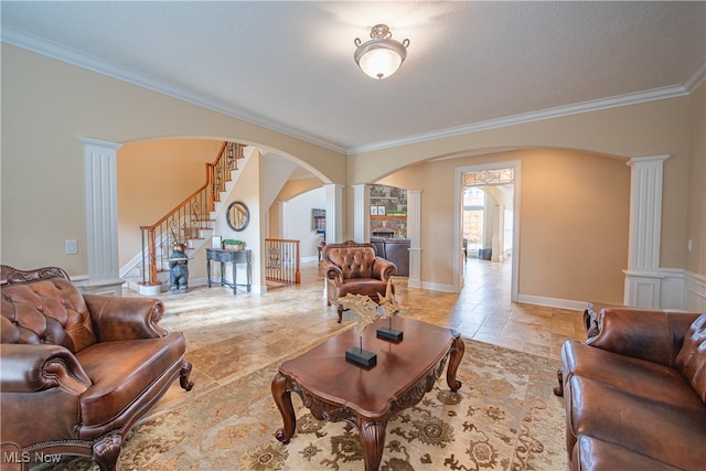 living room featuring crown molding, a textured ceiling, and decorative columns