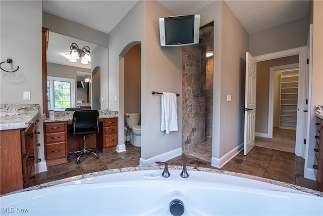 full bathroom featuring toilet, a textured ceiling, independent shower and bath, and vanity