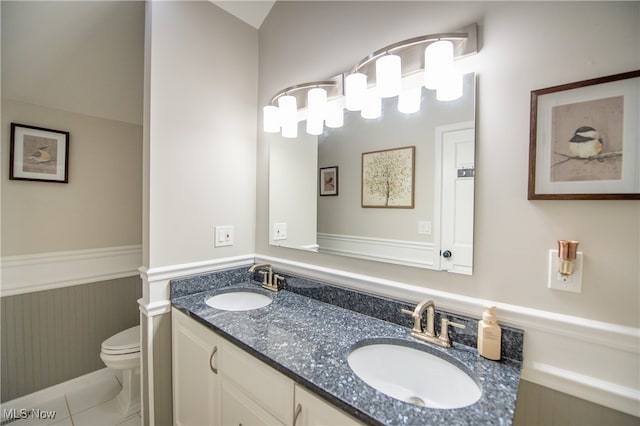 bathroom with vanity, toilet, and tile patterned floors