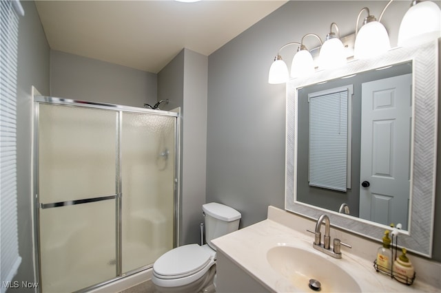 bathroom featuring toilet, walk in shower, and vanity