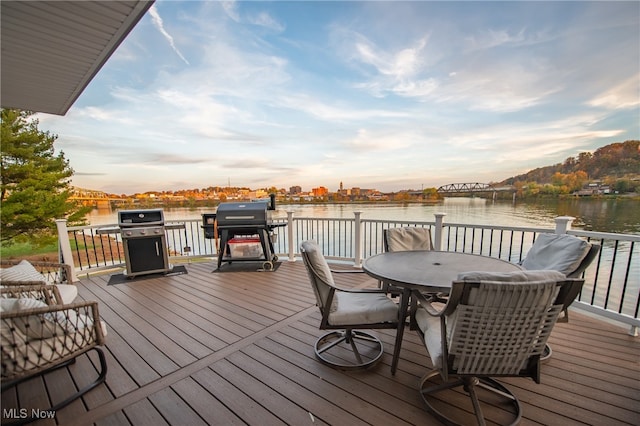 deck featuring a grill and a water view