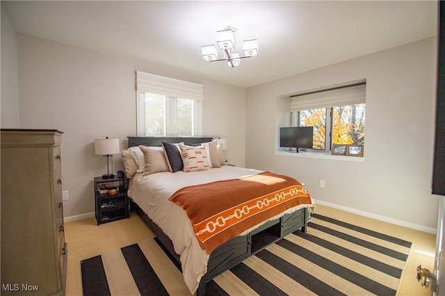 bedroom with multiple windows and light colored carpet