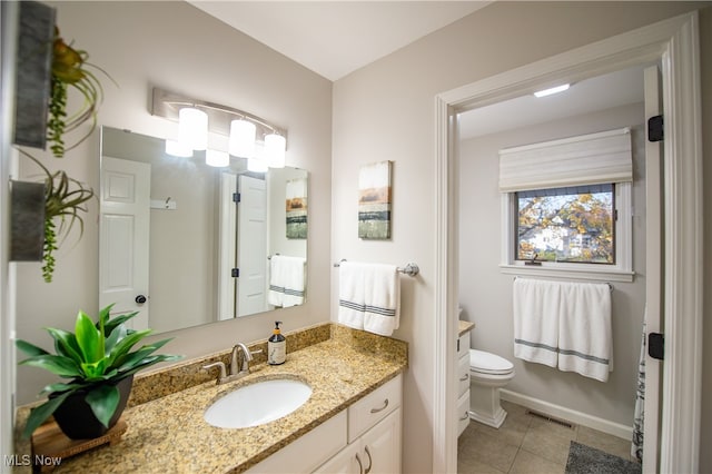 bathroom featuring vanity, toilet, and tile patterned floors