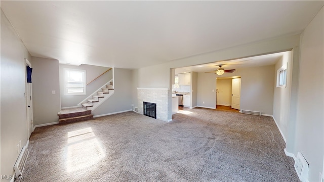 unfurnished living room with carpet floors and ceiling fan