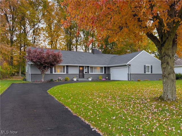 single story home with a garage and a front lawn