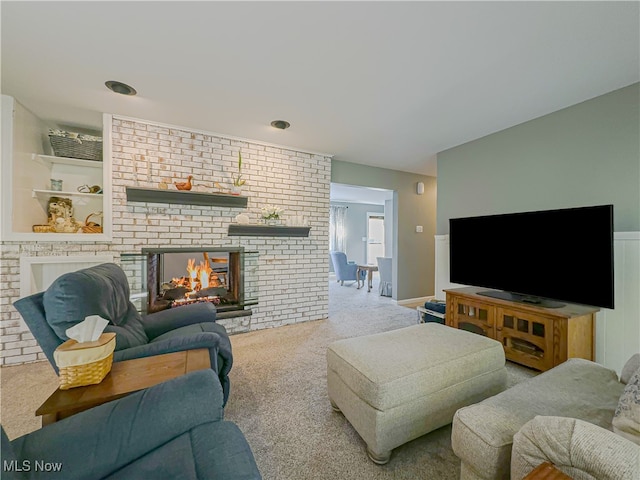 carpeted living room featuring a brick fireplace