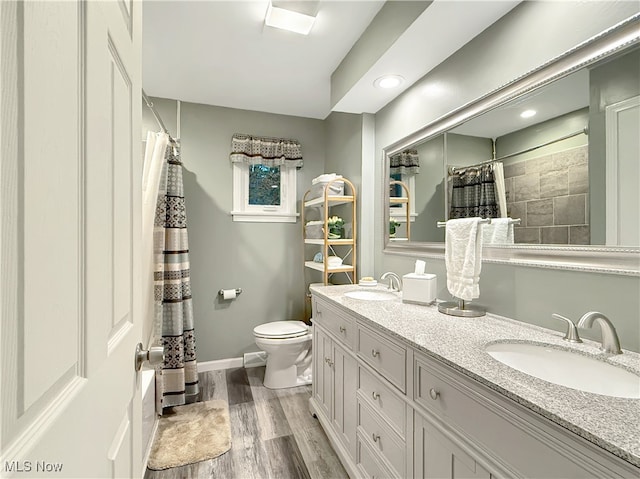 bathroom featuring hardwood / wood-style floors, vanity, and toilet