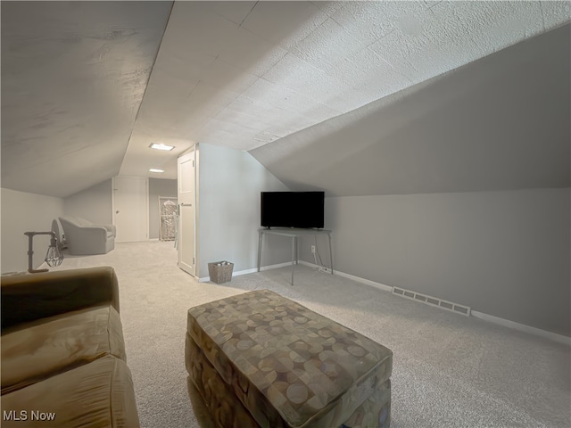 bonus room featuring a textured ceiling, carpet floors, and vaulted ceiling