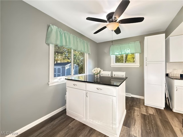 kitchen featuring white cabinetry, a healthy amount of sunlight, and dark hardwood / wood-style floors