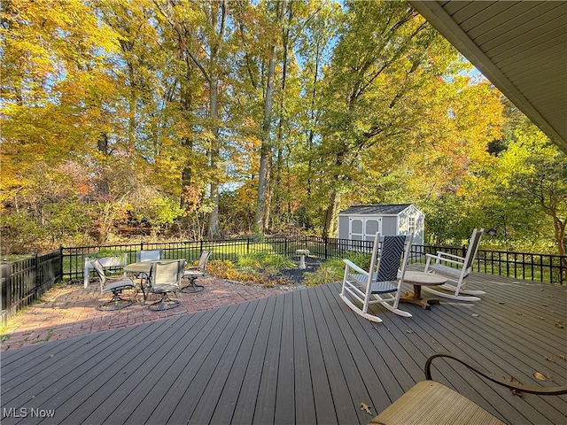 wooden terrace featuring a storage unit