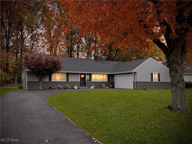 single story home featuring a front yard and a garage