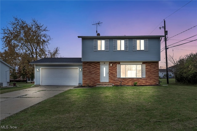 view of front property featuring a yard and a garage