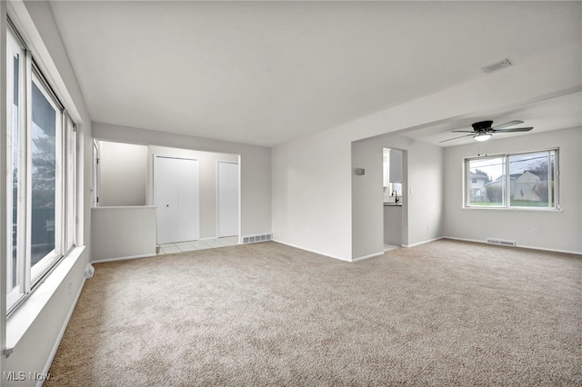 spare room with light carpet and ceiling fan