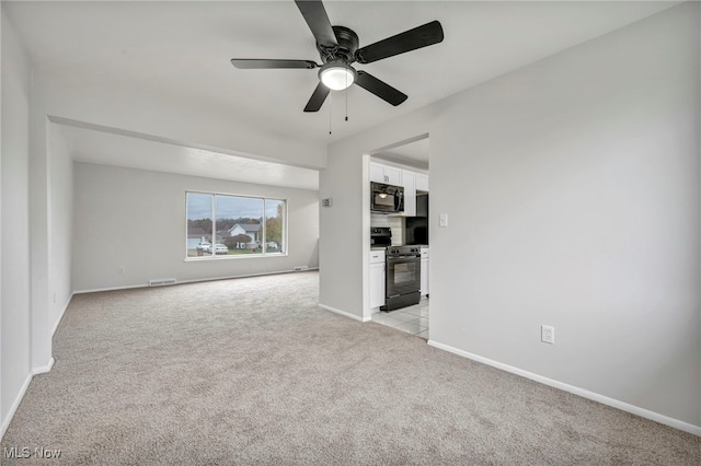 unfurnished living room featuring light colored carpet and ceiling fan