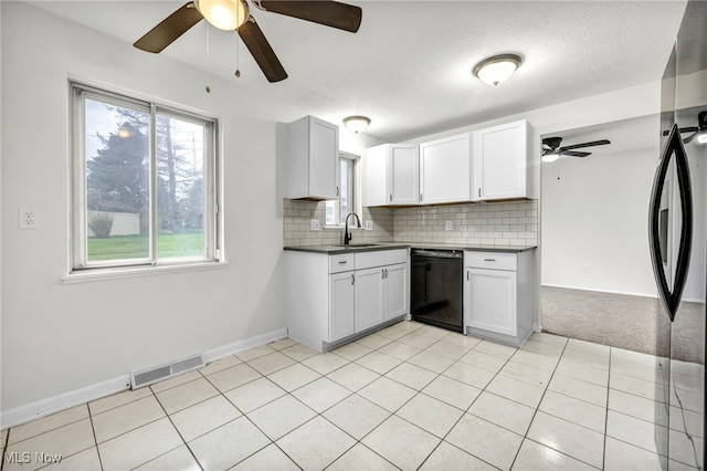 kitchen with white cabinets, tasteful backsplash, light tile patterned floors, dishwasher, and sink