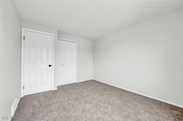 unfurnished bedroom featuring carpet floors and a closet