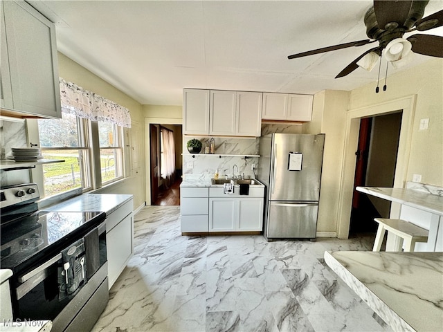 kitchen with ceiling fan, tasteful backsplash, and appliances with stainless steel finishes