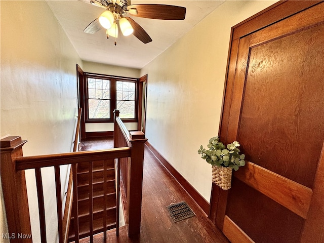 stairway with hardwood / wood-style flooring and ceiling fan