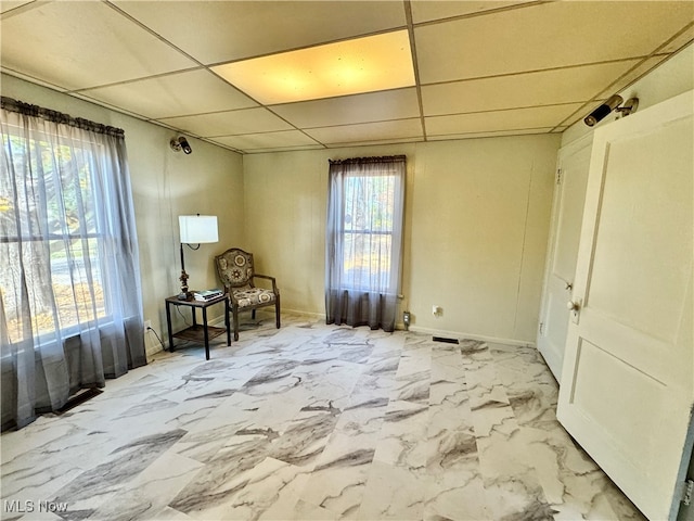 sitting room featuring a paneled ceiling