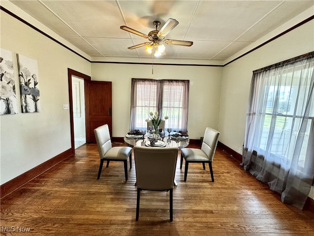 dining area with dark hardwood / wood-style floors and ceiling fan