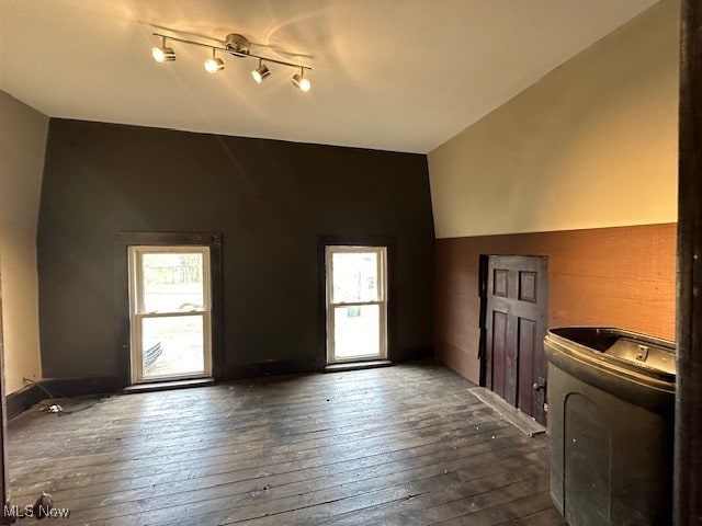 interior space with lofted ceiling, dark wood-type flooring, and washer / clothes dryer