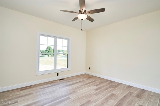 empty room featuring light hardwood / wood-style flooring and ceiling fan