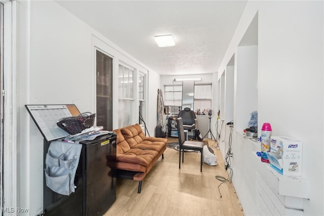 interior space featuring light hardwood / wood-style flooring and a textured ceiling