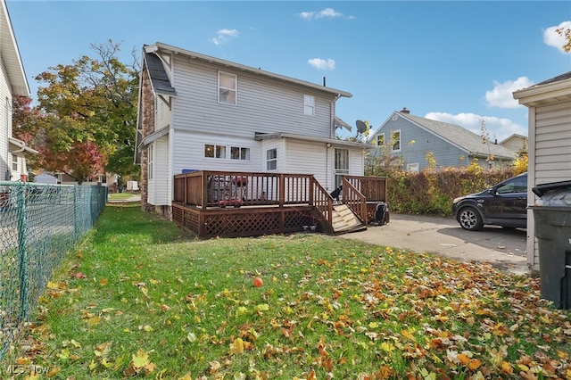 rear view of house with a yard, a deck, and a patio area