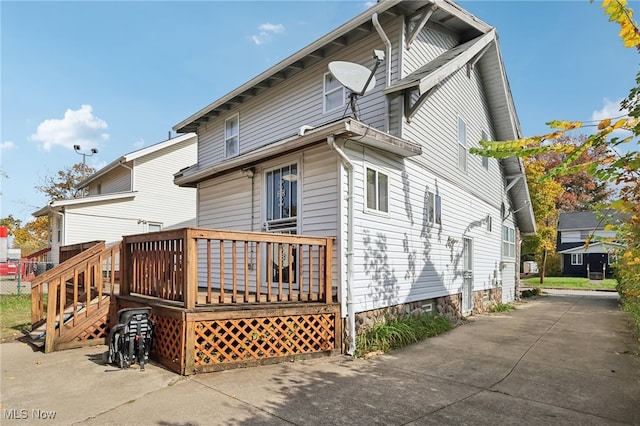 rear view of property with a wooden deck