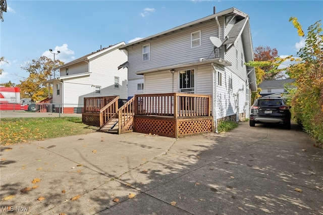 back of property featuring a wooden deck