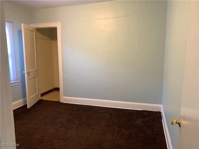 spare room featuring a healthy amount of sunlight and carpet