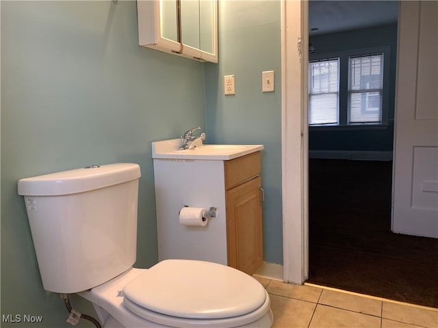 bathroom featuring vanity, tile patterned floors, and toilet